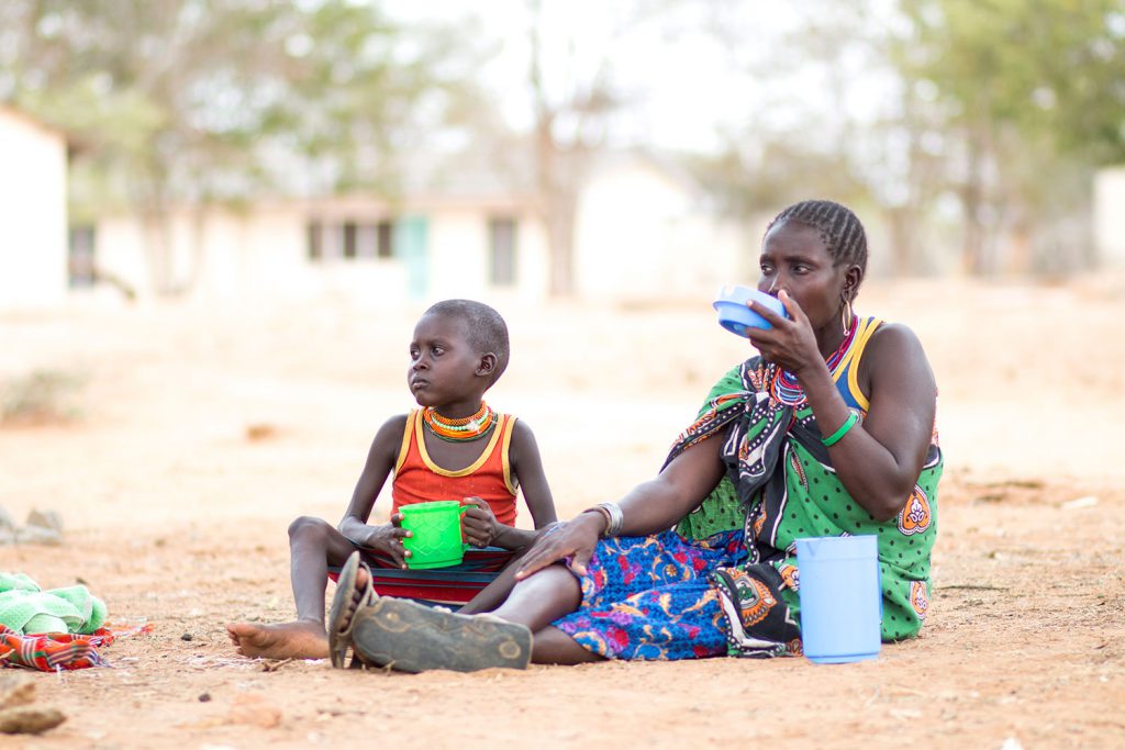 Mother and child sitting outside of the hospital